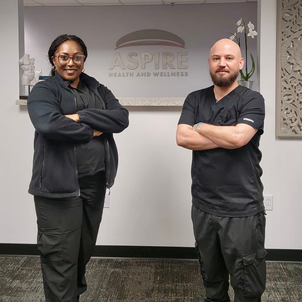 Sonny Demelo and Jasmine Rousseve in front of the Aspire Health & Wellness sign at the Metairie clinic